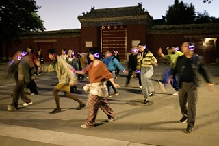 The small flowing crowd danced and roamed around the park, into the silent corners, and through the local “plaza dance” crowds.