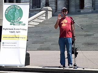 Dave Lowe speaks in front of the parlament
