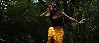 Woman dances in the forest