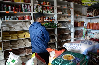 Writer and curator Phokeng Setai stands inside a food store in Salt River
