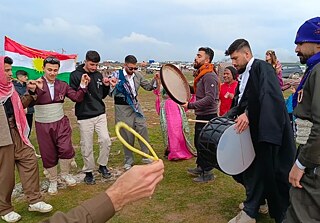 Syrian Kurds in their traditional outfits performing the Kurdish dabke in celebration of Newroz on March 20, Qamishli, Syria.