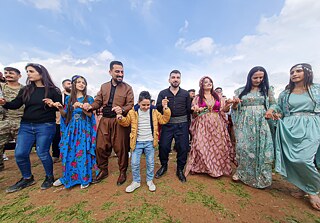 Syrian Kurds in their traditional outfits performing the Kurdish dabke in celebration of Newroz on March 20, Qamishli, Syria.