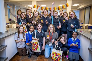 Group of girls aged 10-13 with famous food blogger Maya from FitGreenMind, all hold up muffins