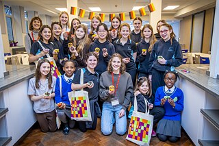 Group of girls aged 10-13 with famous food blogger Maya from FitGreenMind, all hold up muffins
