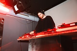 DJ operates a DJ booth
