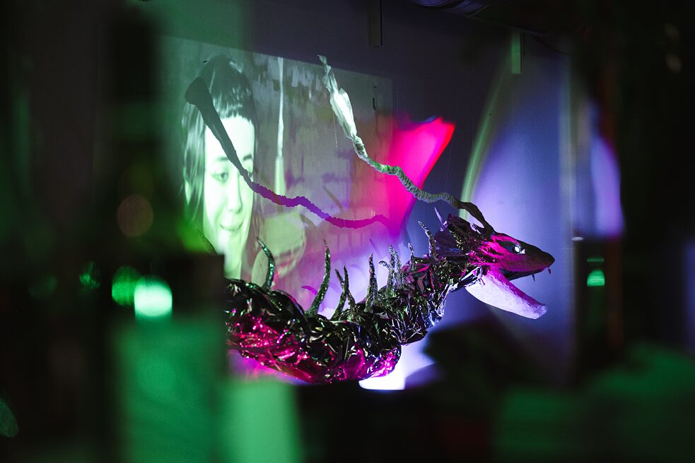 The figure of a dragon hangs in the dark room