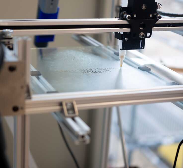 Cloud plotter in action, revealing the title of the research “Carbon Technostructure” from a layer of water steam