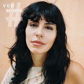 Forfatteren Şeyda Kurt er fotograferet skråt oppefra, Kurt har mørkt langt hår og er iført en hvid top, baggrunden er brunrosa.