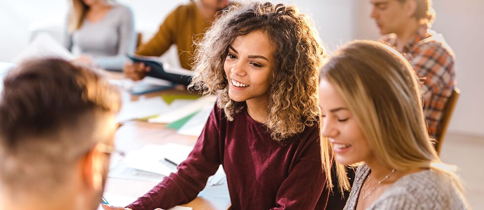 Two young women are writing an exam.