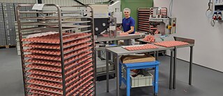 An employee of Marzipan Manufaktur making marzipan Santas