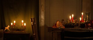 Candles burning on a brown wooden table