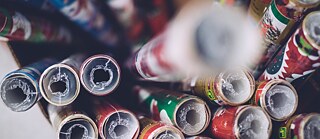 Bird's eye view of several rolls of colourful wrapping paper in a box