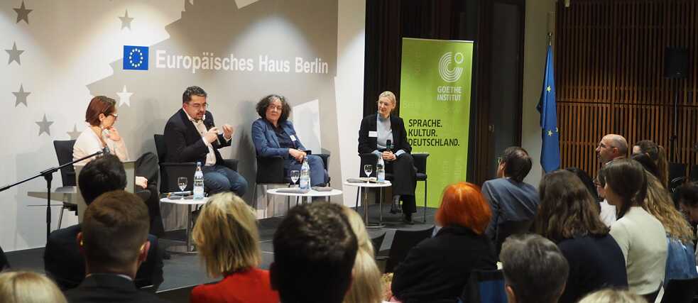 Diskussion auf dem Podium im Europäischen Haus in Berlin mit vier Personen und Publikum.