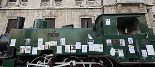 A horse is harnessed to a cart, accompanied by three men on the street.