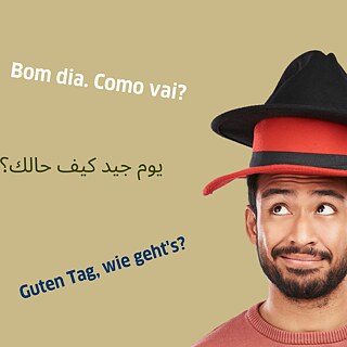 Man with two hats on his head and several languages in the background