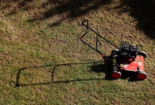 A lawnmower on a mowed lawn