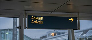 A sign displaying "Ankunft" and "Arrivals" indicating the arrivals section. © © Unsplash Arrivals Information Board