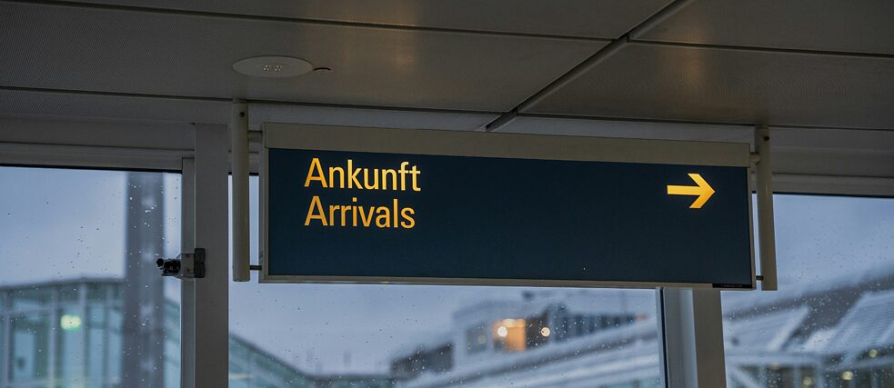 A sign displaying "Ankunft" and "Arrivals" indicating the arrivals section.