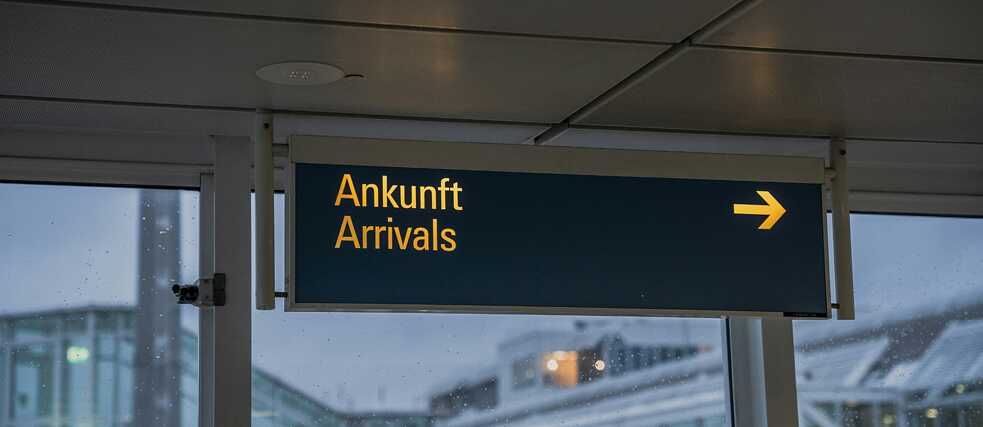 A sign displaying "Ankunft" and "Arrivals" indicating the arrivals section.