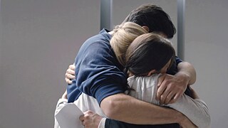 Three people hugging