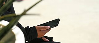 A hand is holding a smart phone