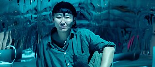 A portrait of Anne Duk Hee Jordan in blue colours