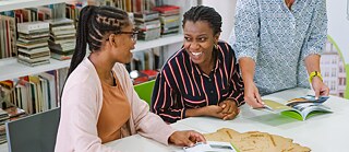 Two ladies in light-hearted conversation with each other 