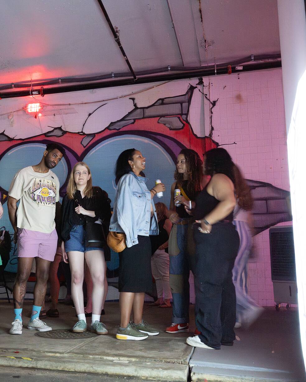 Four people looking at a work of art as part of the Berlin Underground exhibition in Washington, DC