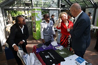 Four people talk at the information table of the Sub-Saharan Africa region