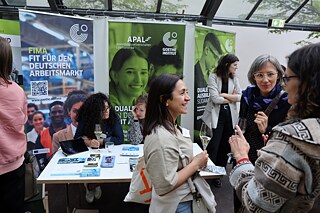 Several people talk in front of the information desk of the South America region