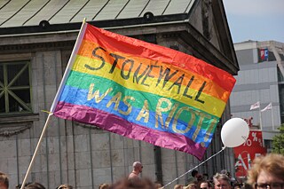 "Stonewall was a Riot" on a rainbow flag at Christopher Street Day in Berlin 2018