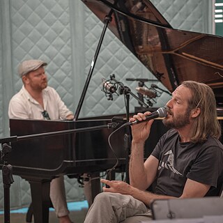 Goethe In-Sessions, Mann am Piano und Mann sitzend mit Mikrofon singend