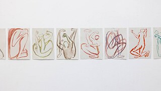 Multiple artistic drawings arranged on a white wall, highlighting diverse creativity and artistic expression.