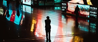 A person standing in the midst of screens