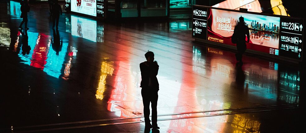 A person standing in the midst of screens