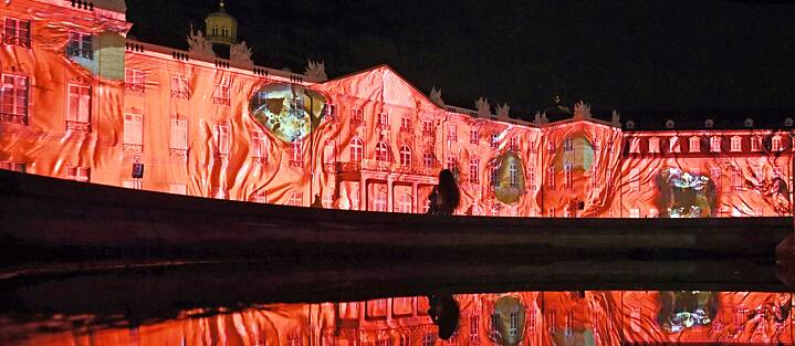 Where does the building stop, where does the projection start, and what is merely a reflection? The artwork “Defile” by DSG.