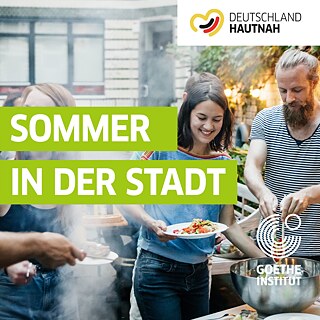 A group of young people having a barbecue in a courtyard.