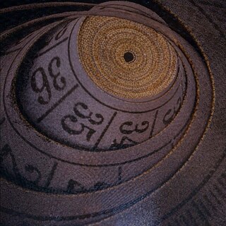 A tapemeasure that has been spiraled out with the viewpoint looking up into it