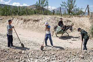 Residents of Kök-Tash village, Kyrgyzstan, digging an irrigation canal to water their gardens. Due to shortages, they are only allowed to water their fruit and vegetable gardens once a year. 