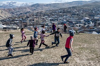 Children play on a hill near Sülüktü city, Kyrgyzstan.