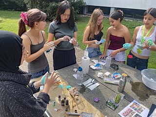 Jugendliche färben Seifenmasse.