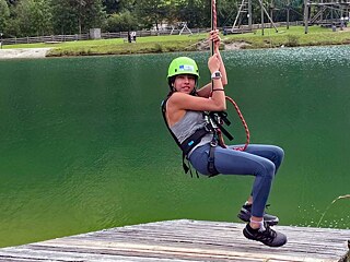 Jugendliche am Flying Fox über einen See.