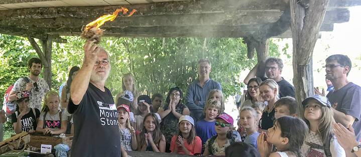 The museum gives vivid and practical demonstrations of everyday life in the prehistoric period: children here are learning how people would have lit a fire back then.