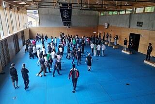 Jugendliche in einer großen Sporthalle.