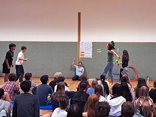 Jugendliche werfen Schirmmützen, andere sehen dabei zu.