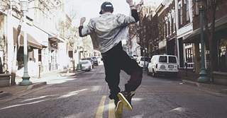 A man doing freestyle dancing on the streets