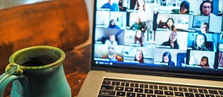 coffee mug in front of laptop