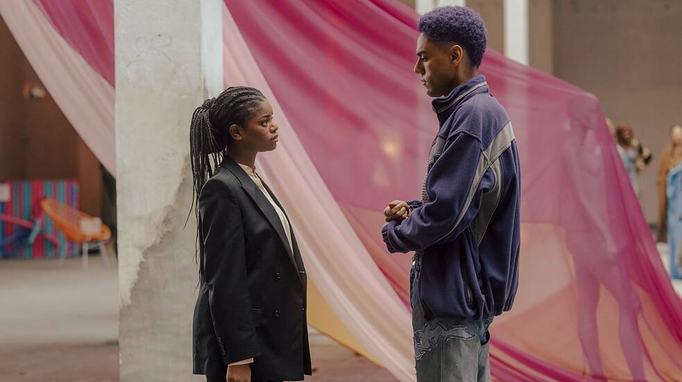 Despite their argument, Karla (Melodie Simina, left) looks at Lalo's (Lamin Leroy Gibba) installation.