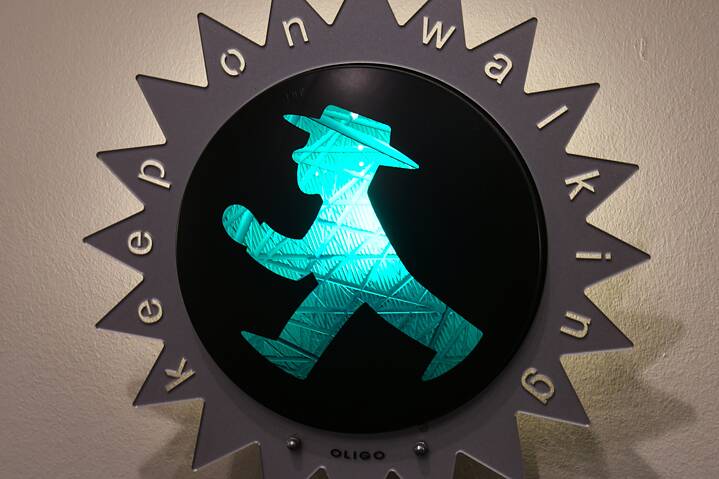 Green traffic light man in decorative wall light