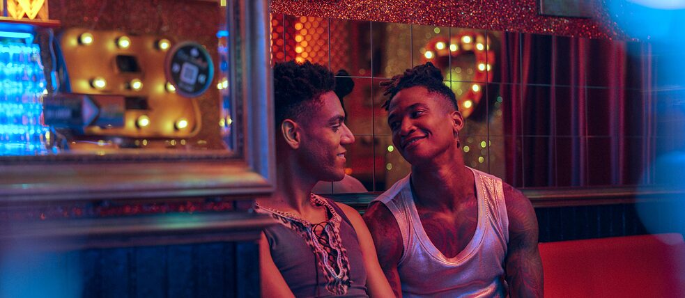 Lalo (Lamin Leroy Gibba) and Joshua (Daniel Hernandez) looking at each other